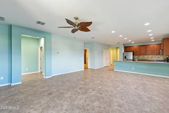 a view of an empty room with a kitchen