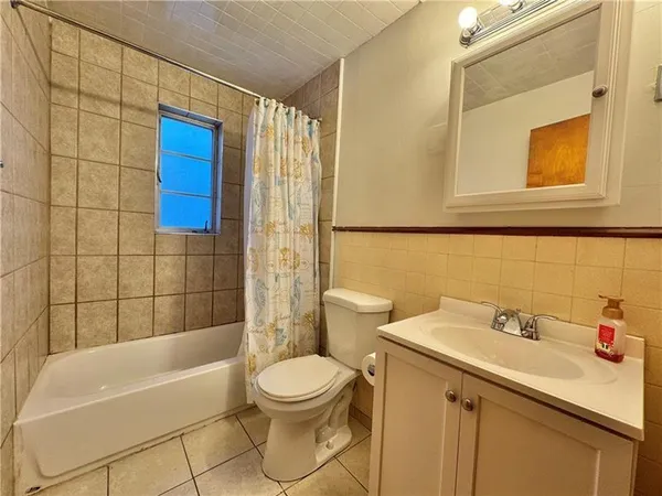 a bathroom with a sink mirror toilet and bathtub