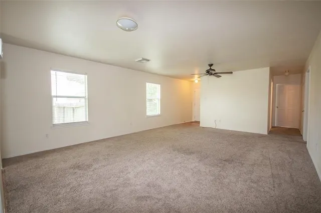 an empty room with windows and closet
