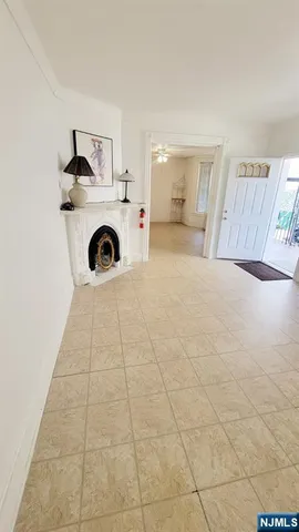 a living room with a rug and white walls