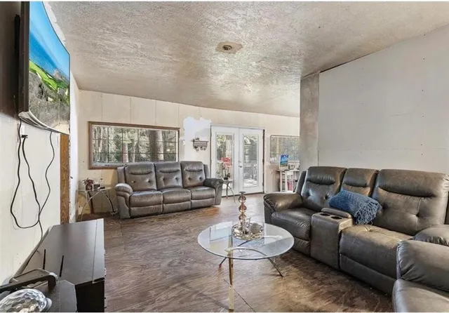 a living room with furniture and a floor to ceiling window