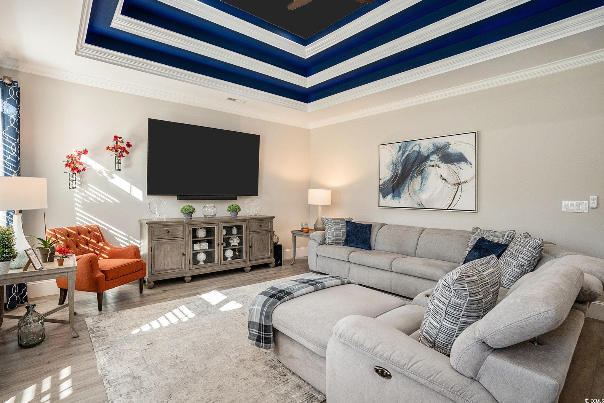 1009 Dowitcher Drive Conway, SC 29526 - Photo 11 of 40 Living area with a tray ceiling, ornamental molding, and wood finished floors