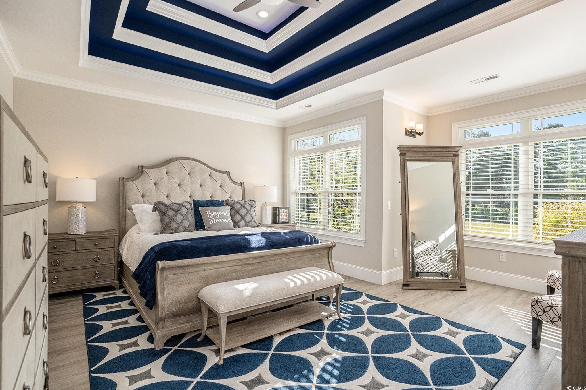 1009 Dowitcher Drive Conway, SC 29526 - Photo 15 of 40 Bedroom featuring ornamental molding, a tray ceiling, light wood finished floors, and a ceiling fan