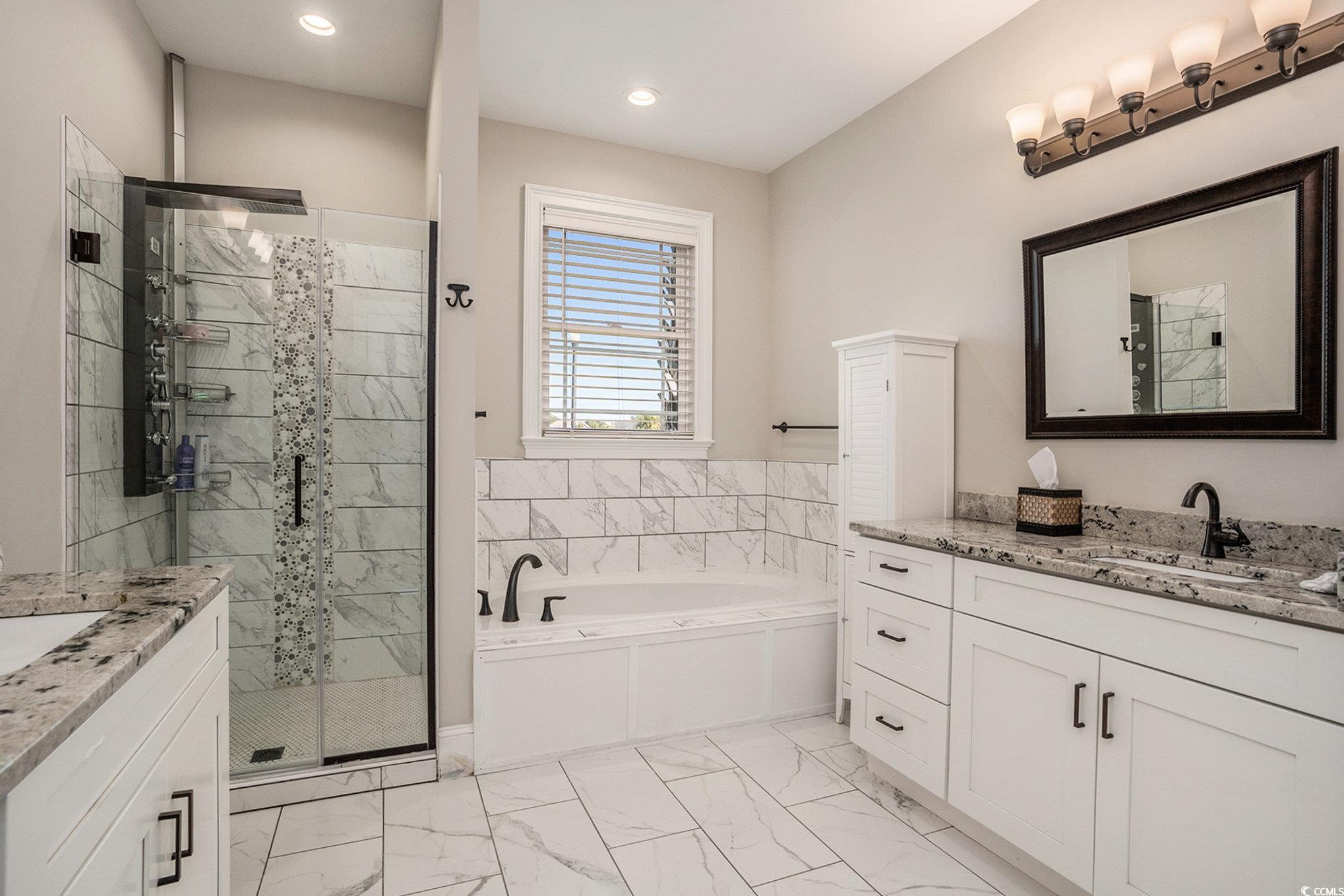 1009 Dowitcher Drive Conway, SC 29526 - Photo 18 of 40 Full bath featuring vanity, a garden tub, light marble finish floors, a stall shower, and recessed lighting