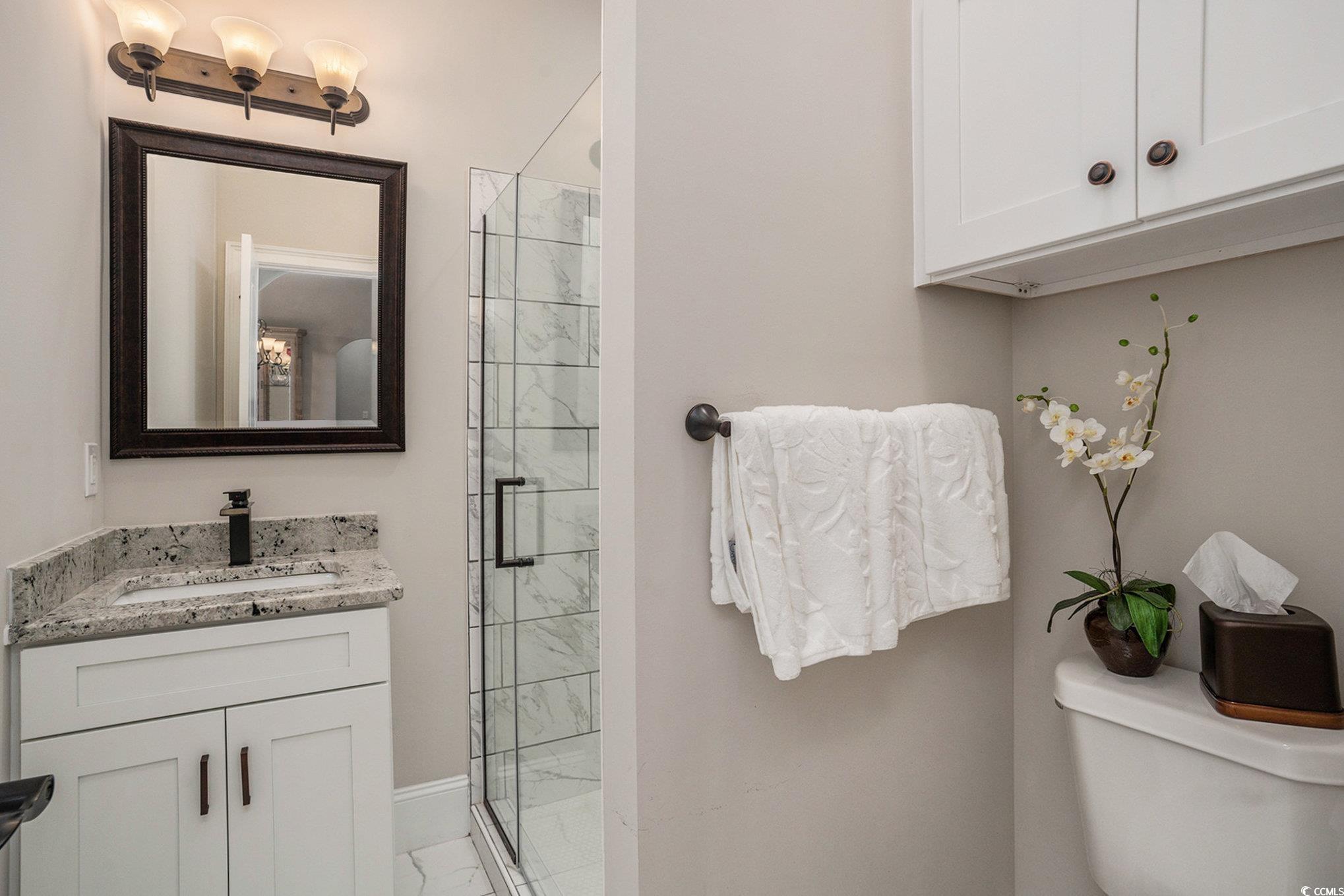 1009 Dowitcher Drive Conway, SC 29526 - Photo 27 of 40 Full bathroom featuring vanity, a stall shower, and light marble finish floors