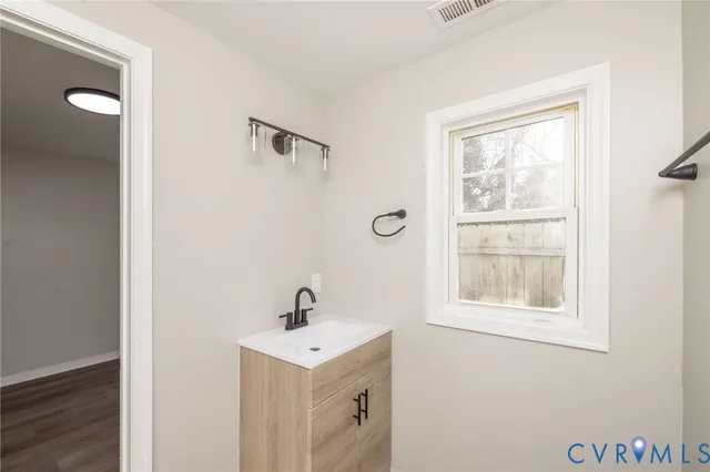 a bathroom with a sink a mirror and window
