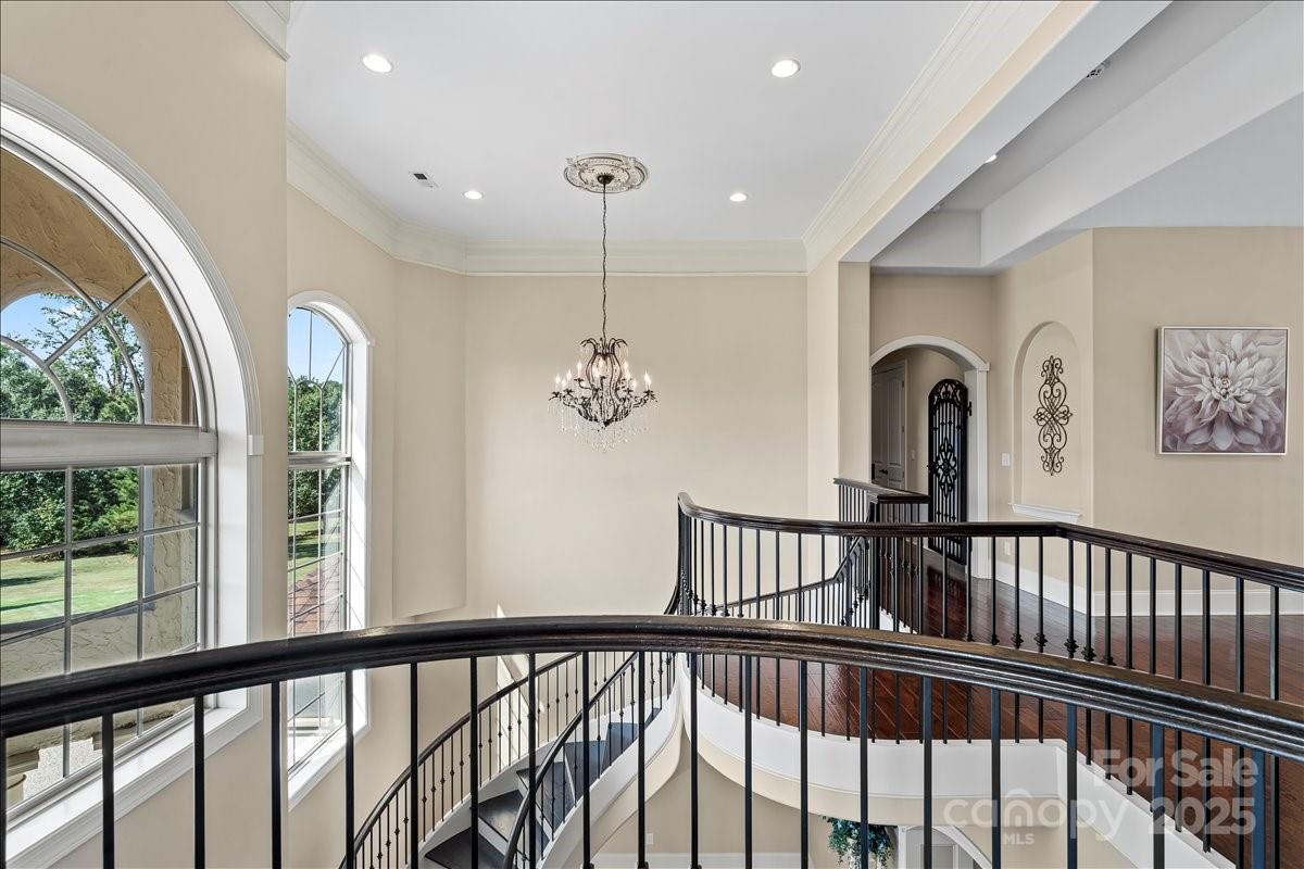 220 Fincher Road Pauline, SC 29374 - Photo 9 of 48 a view of staircase with railing and a chandelier