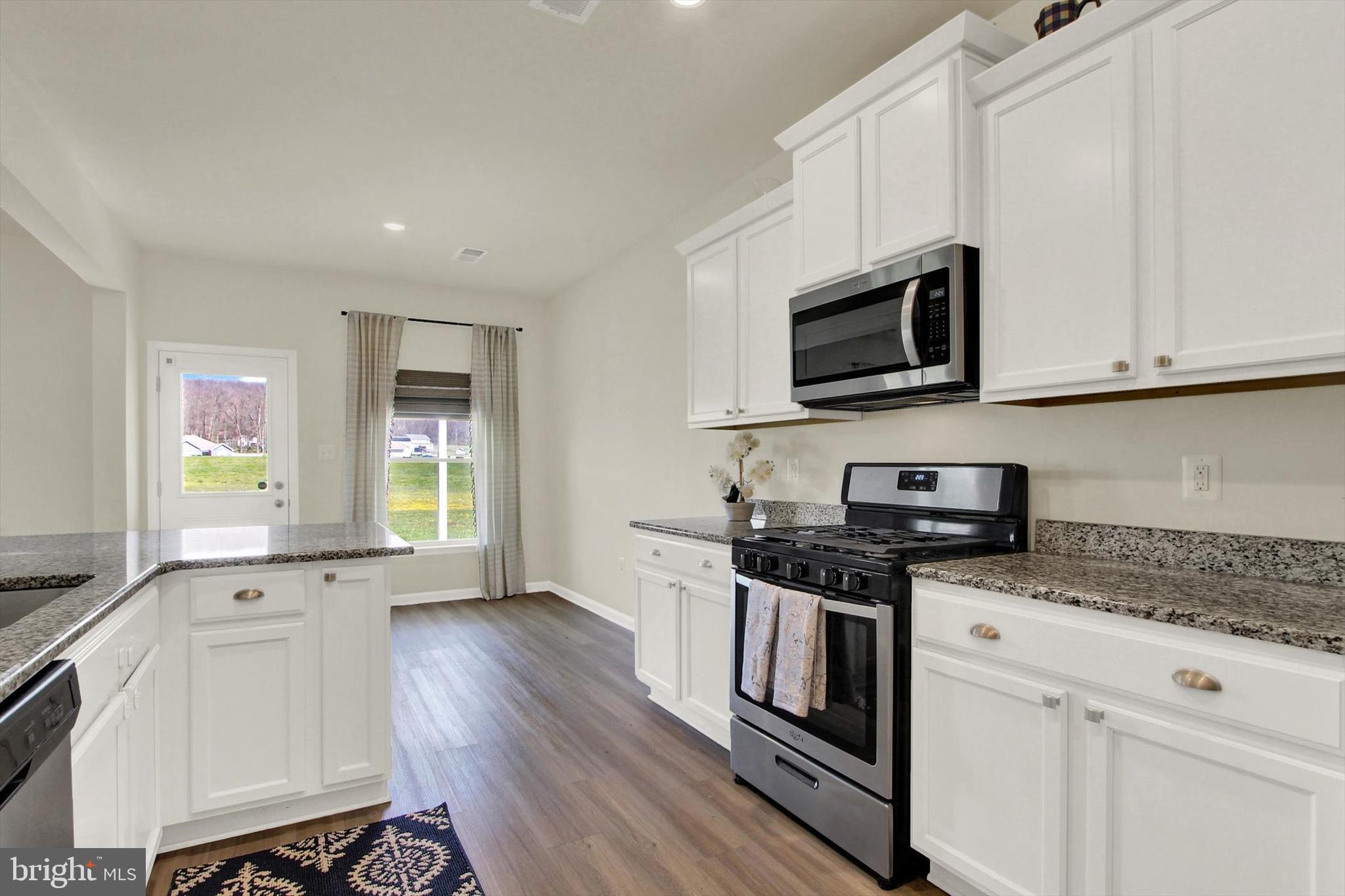 251 Piedmont Way Hanover, PA 17331 - Photo 12 of 29 a kitchen with stainless steel appliances white cabinets and a stove top oven
