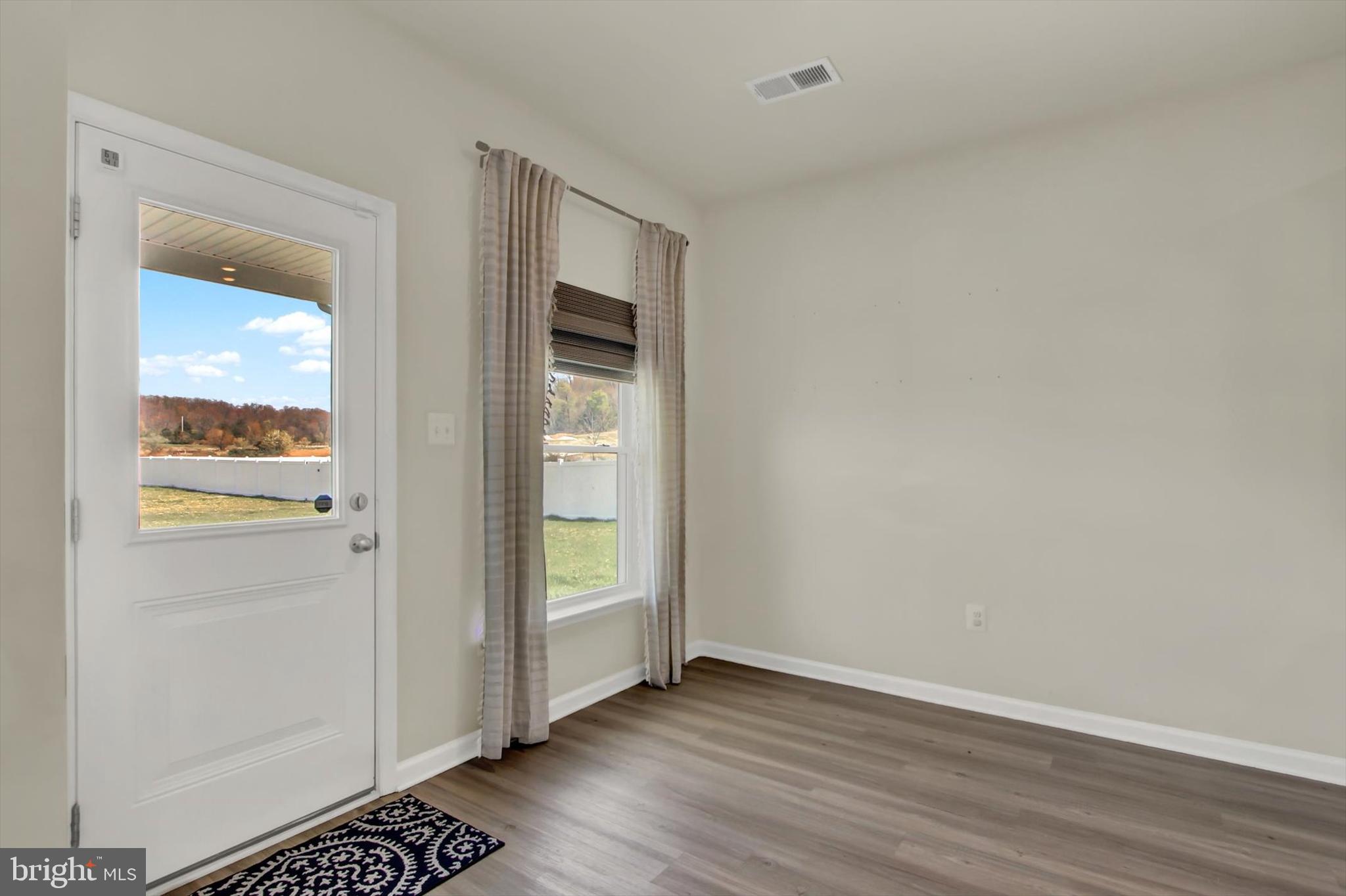 251 Piedmont Way Hanover, PA 17331 - Photo 7 of 29 an empty room with wooden floor and windows
