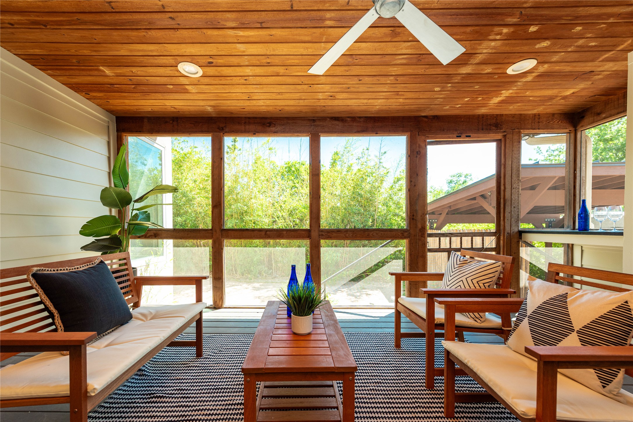 503 East 46th Street Austin, TX 78751 - Photo 22 of 25 Screened porch featuring a natural wood plank ceiling, recessed lighting, ceiling fan, and shiplap wall paneling