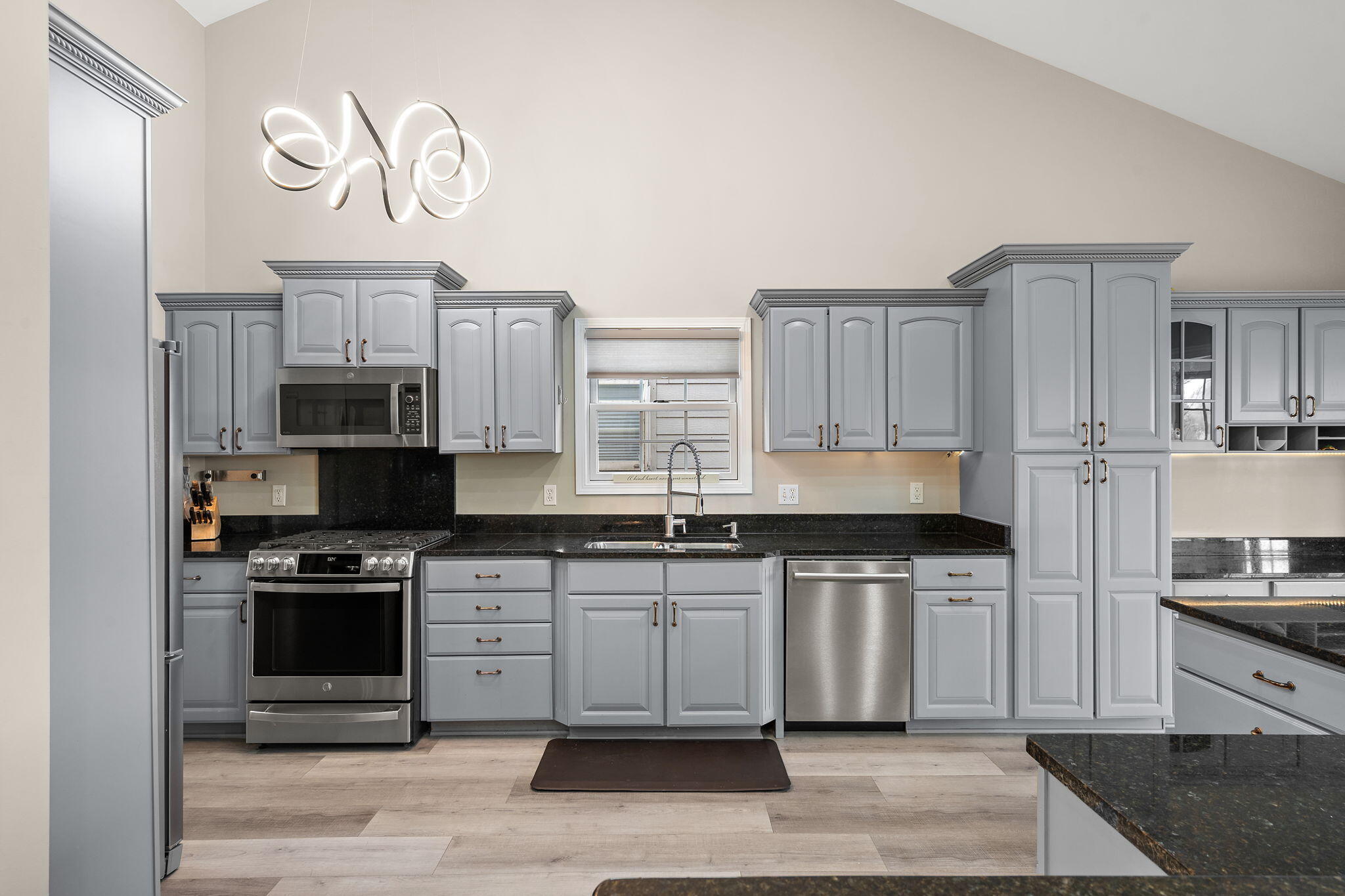 8331 Doubletree Drive North Crown Point, IN 46307 - Photo 14 of 49 a kitchen with stainless steel appliances granite countertop a stove a sink and a refrigerator