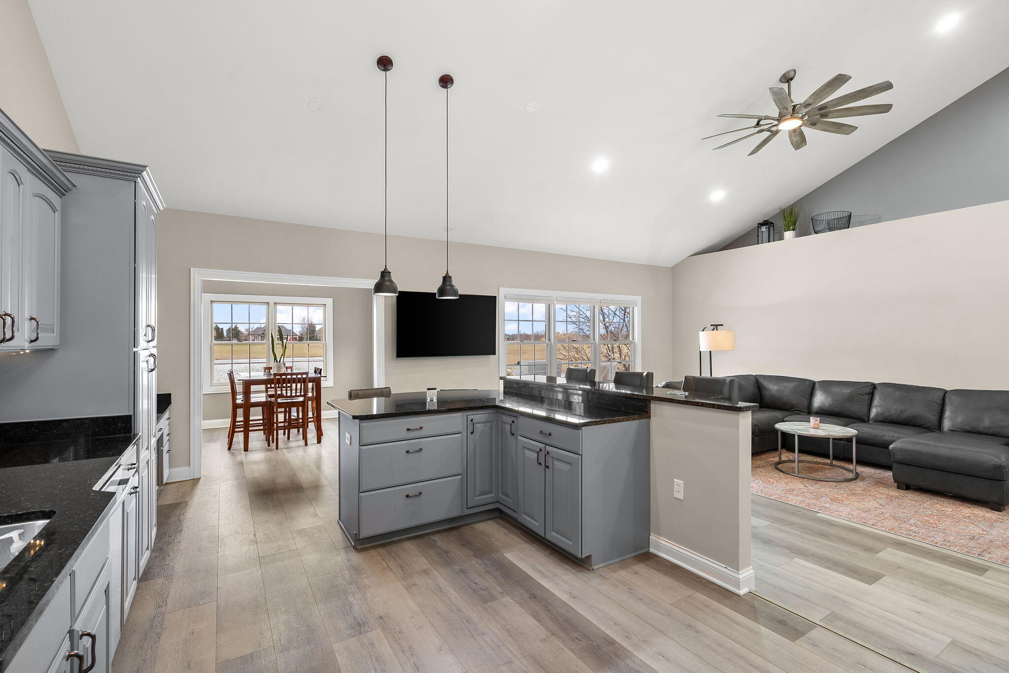 8331 Doubletree Drive North Crown Point, IN 46307 - Photo 15 of 49 a living room with furniture flat screen tv and kitchen view