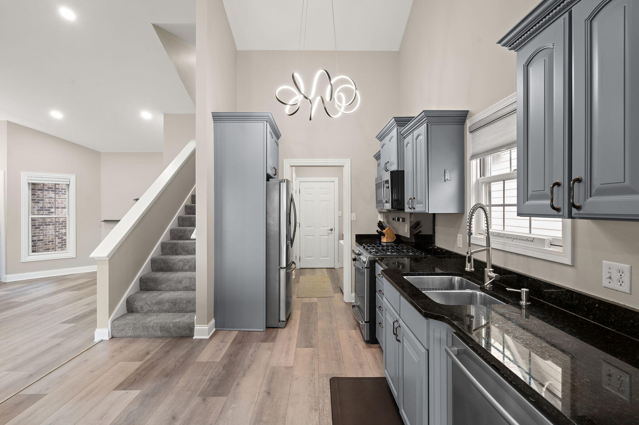 8331 Doubletree Drive North Crown Point, IN 46307 - Photo 16 of 49 a kitchen with granite countertop a stove and a sink
