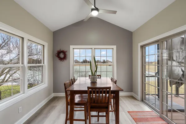 a view of a dining room with furniture large windows and wooden floor