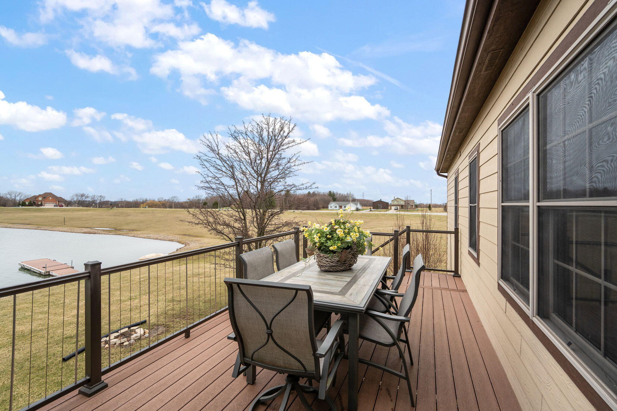 8331 Doubletree Drive North Crown Point, IN 46307 - Photo 19 of 49 a view of a balcony with wooden chairs and ocean view