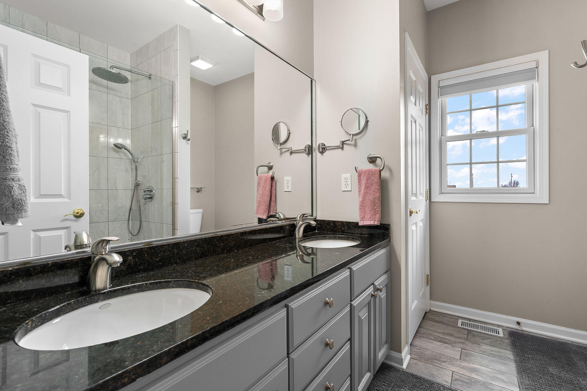 8331 Doubletree Drive North Crown Point, IN 46307 - Photo 22 of 49 a bathroom with a granite countertop sink a mirror and a shower