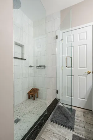 a bathroom with a granite countertop sink a toilet and shower