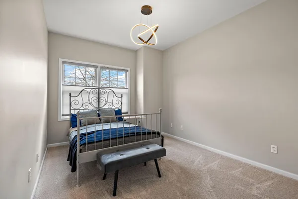 a bedroom with a bed and window