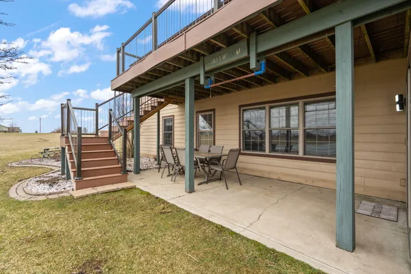 a view of a patio with a table and chairs