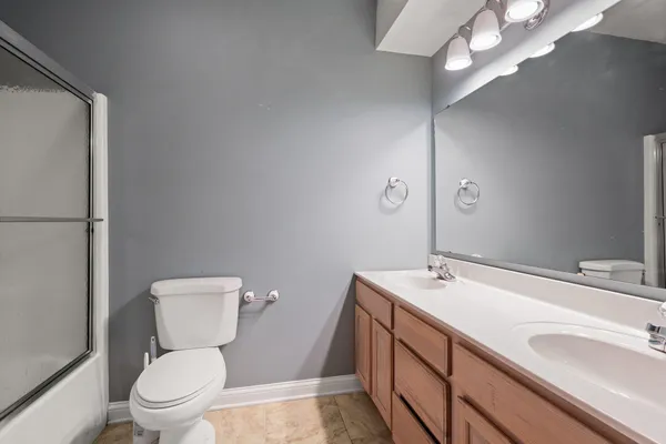 a bathroom with a sink a toilet a mirror and vanity