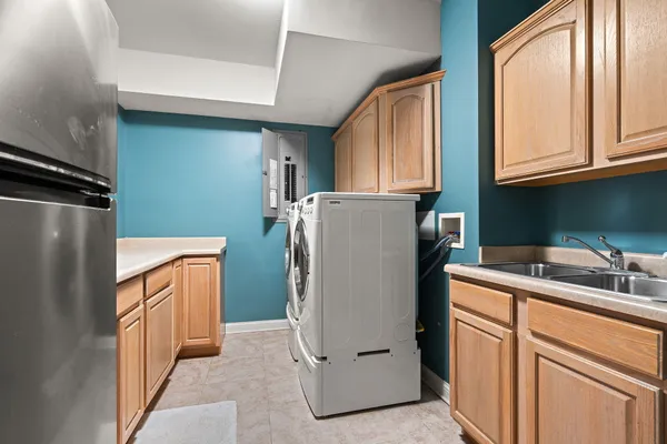 a utility room with wooden floor washer and dryer