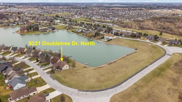 an aerial view of a house with a lake view