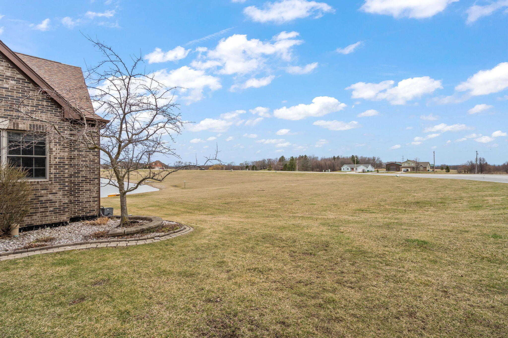 8331 Doubletree Drive North Crown Point, IN 46307 - Photo 45 of 49 a view of a lake with a yard