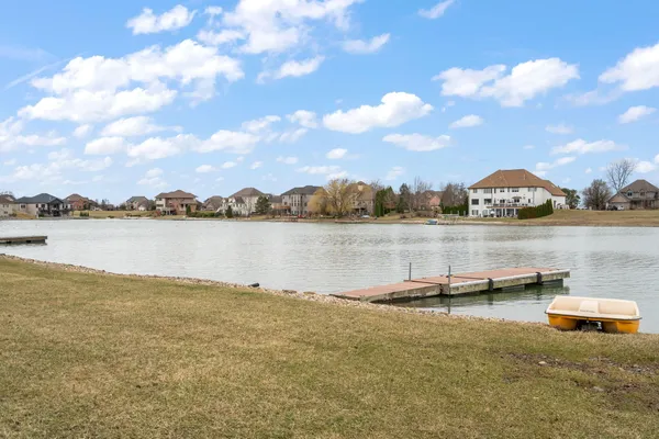 a view of a lake with houses in the back