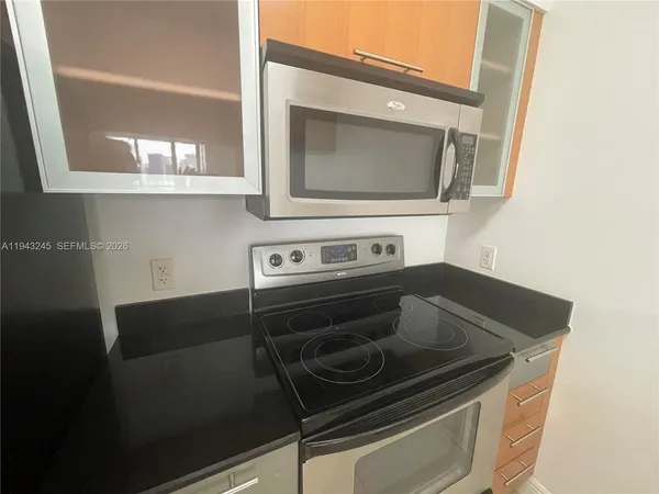 a stove top oven sitting inside of a kitchen