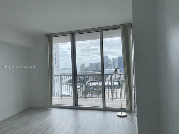 a view of a room with wooden floor and doors