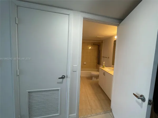 a view of a bathroom from a hallway