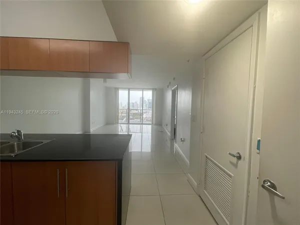 a kitchen with granite countertop a sink and wooden cabinets