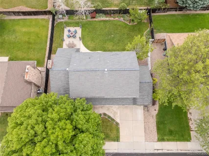 an aerial view of a house with a yard and lake view