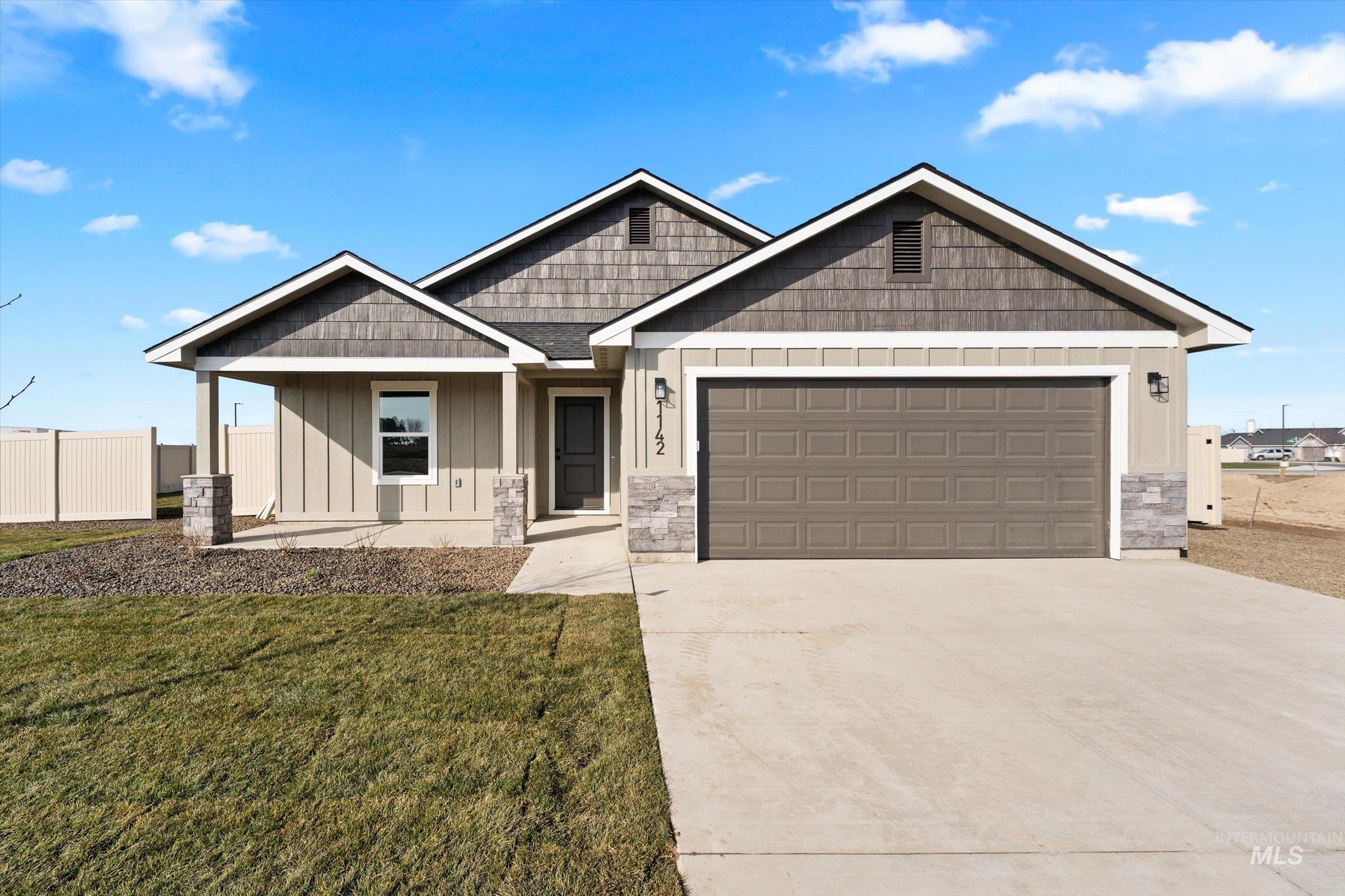 Craftsman-style home featuring stone siding, concrete driveway, and a porch