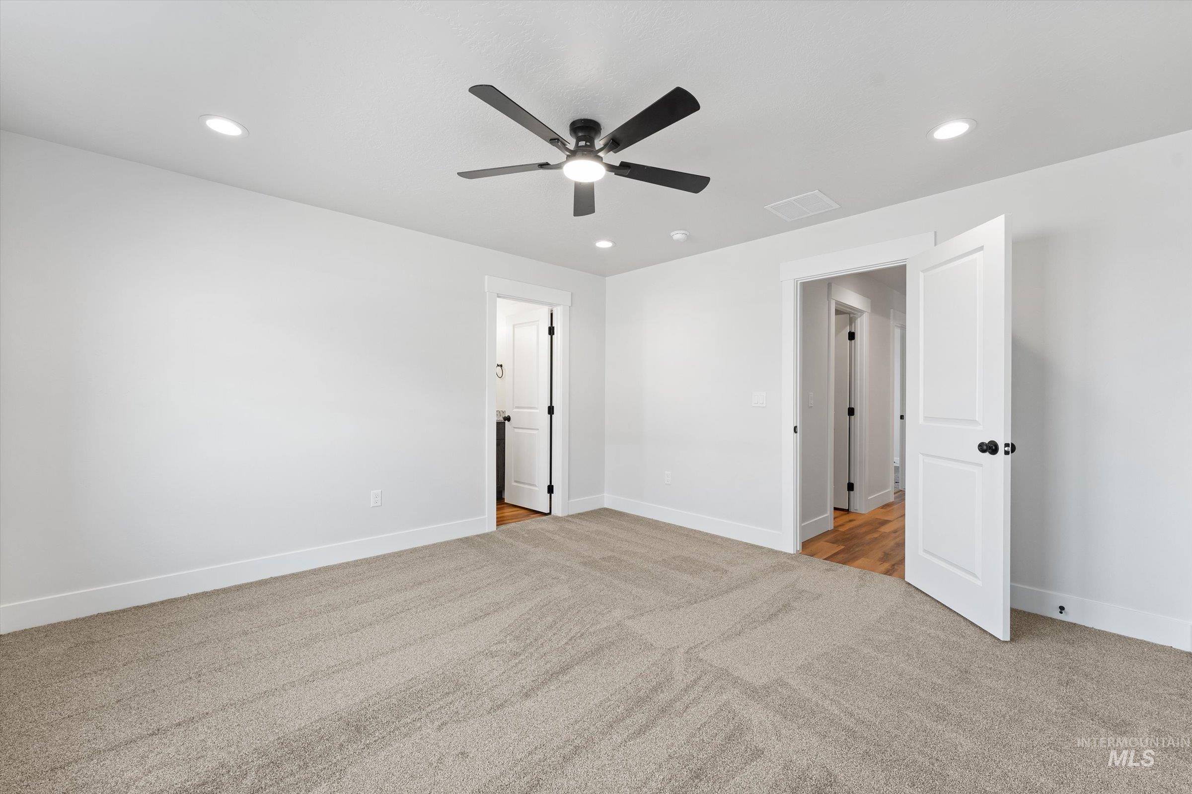 1142 Velvet Loop Wilder, ID 83676 - Photo 9 of 27 Unfurnished bedroom featuring light colored carpet, ceiling fan, and recessed lighting