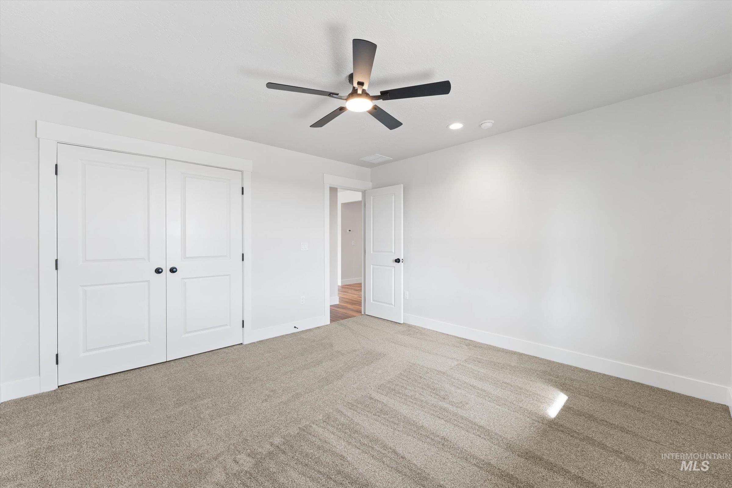 1142 Velvet Loop Wilder, ID 83676 - Photo 11 of 27 Unfurnished bedroom with carpet floors, ceiling fan, recessed lighting, and a closet