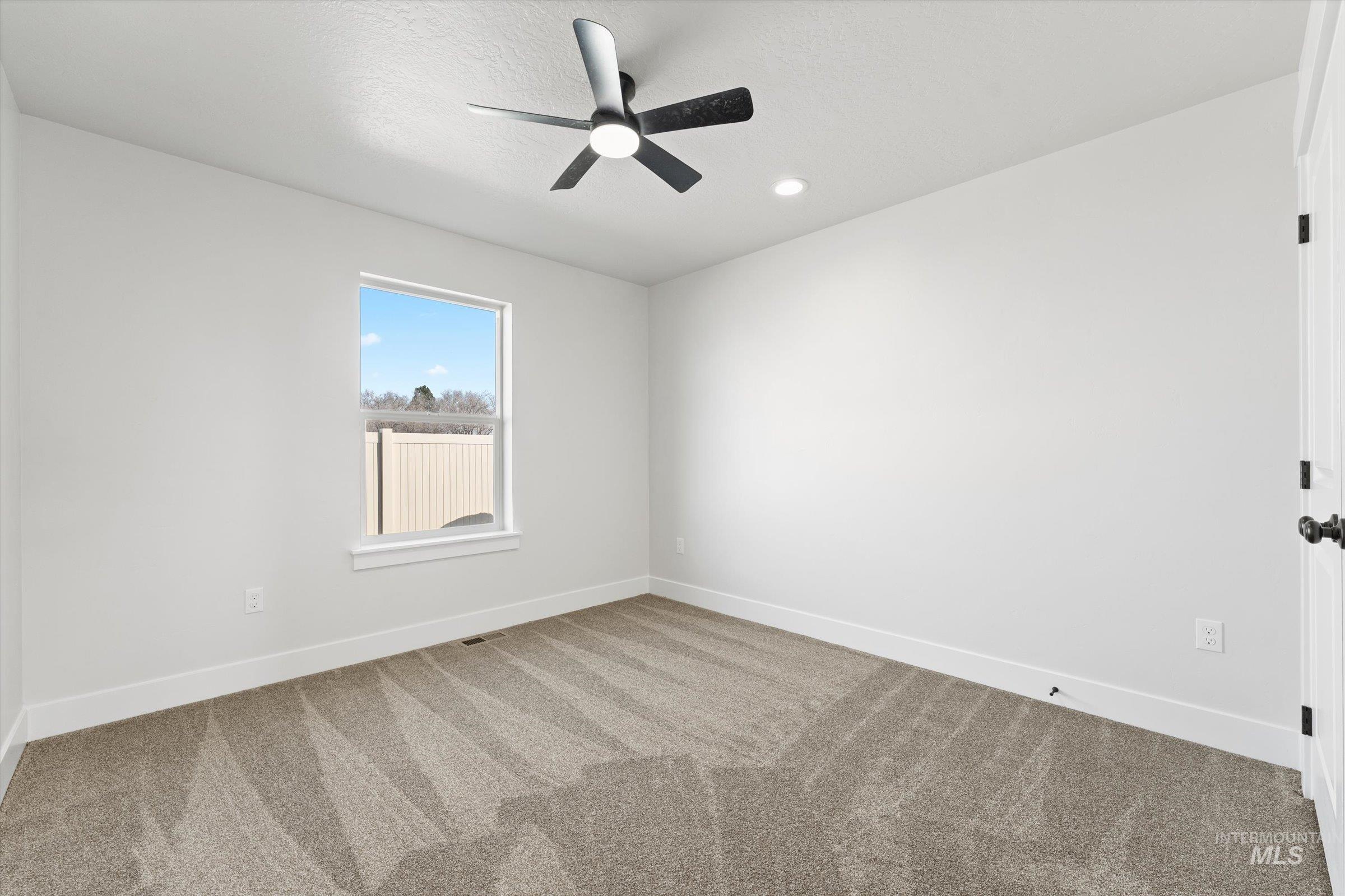 1142 Velvet Loop Wilder, ID 83676 - Photo 16 of 27 Unfurnished room featuring carpet, a ceiling fan, and recessed lighting