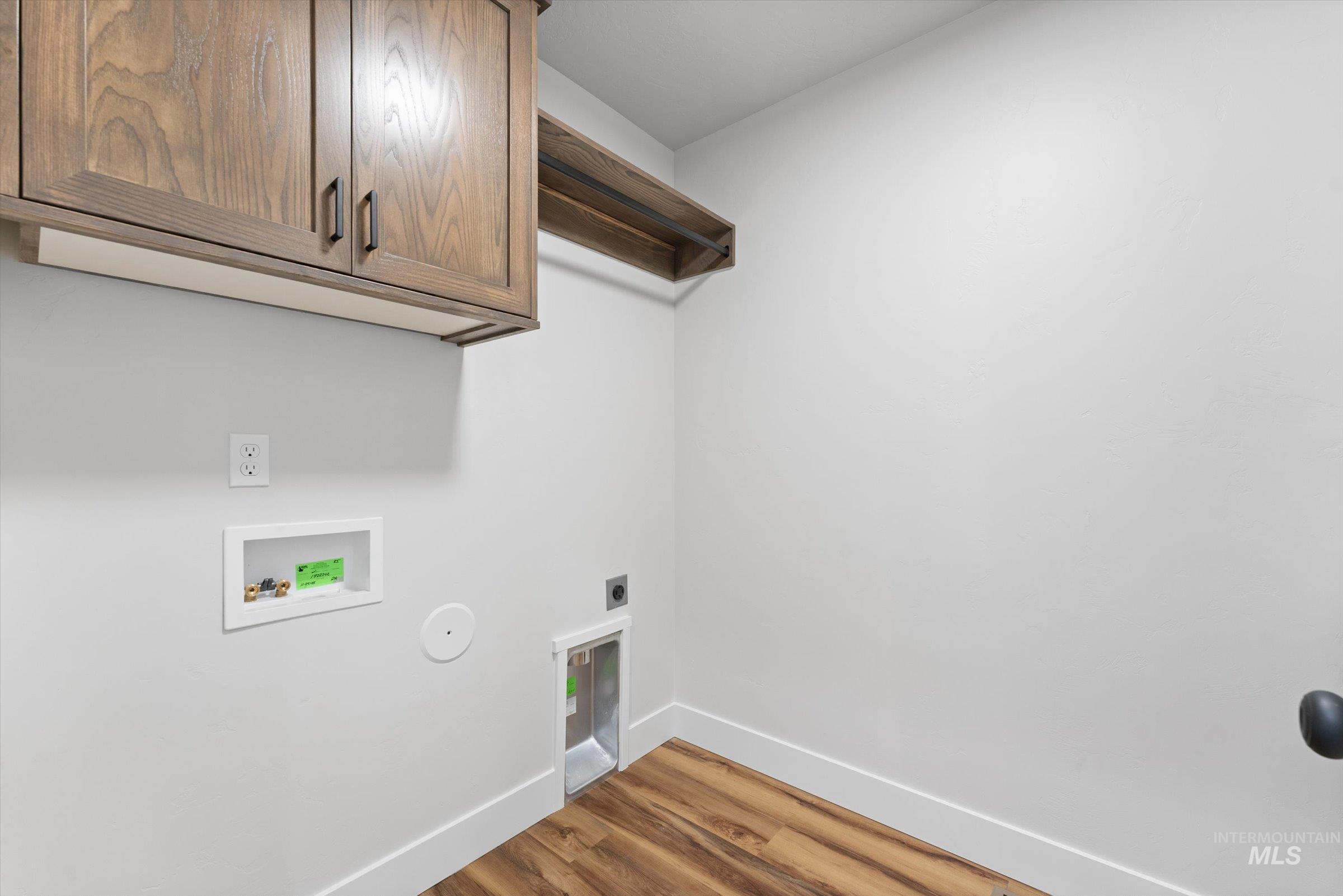1142 Velvet Loop Wilder, ID 83676 - Photo 19 of 27 Laundry room with cabinet space, wood finished floors, washer hookup, and hookup for an electric dryer