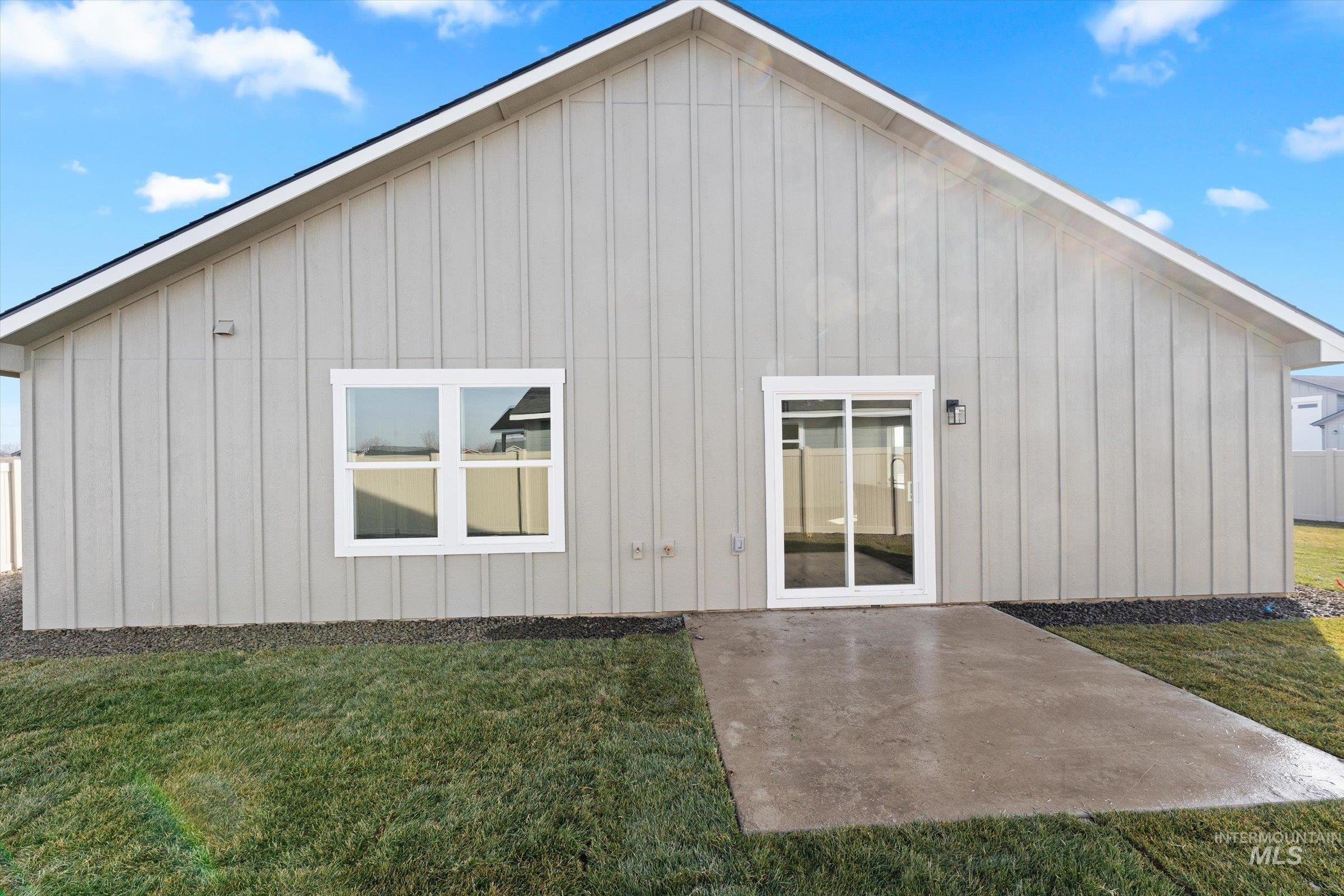 1142 Velvet Loop Wilder, ID 83676 - Photo 21 of 27 Rear view of house featuring board and batten siding and a patio