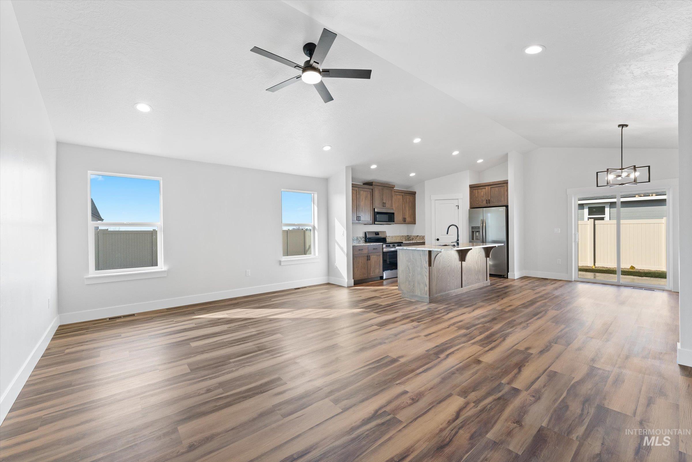 1142 Velvet Loop Wilder, ID 83676 - Photo 25 of 27 Kitchen with open floor plan, a breakfast bar area, a kitchen island with sink, a ceiling fan, and lofted ceiling