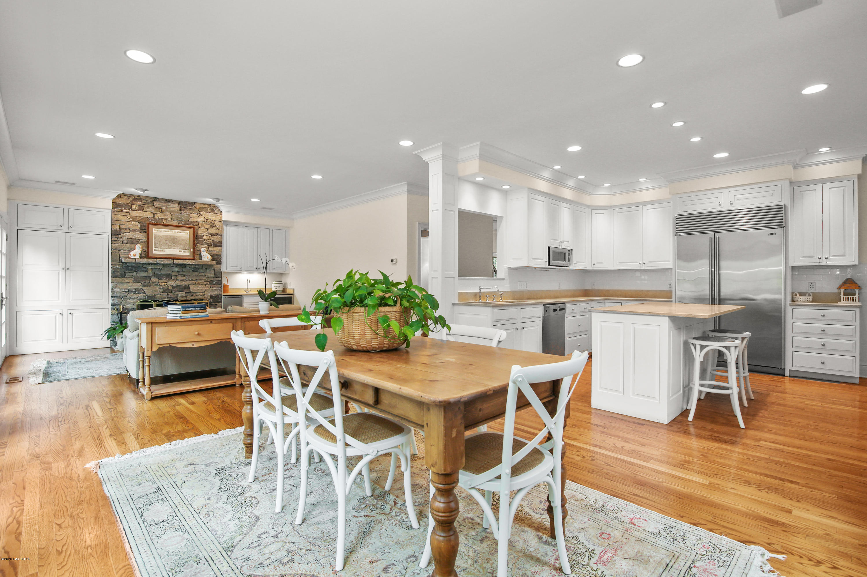 82 Round Hill Road Greenwich, CT 06831 - Photo 13 of 19 a kitchen with stainless steel appliances kitchen island granite countertop a kitchen island and chairs in it