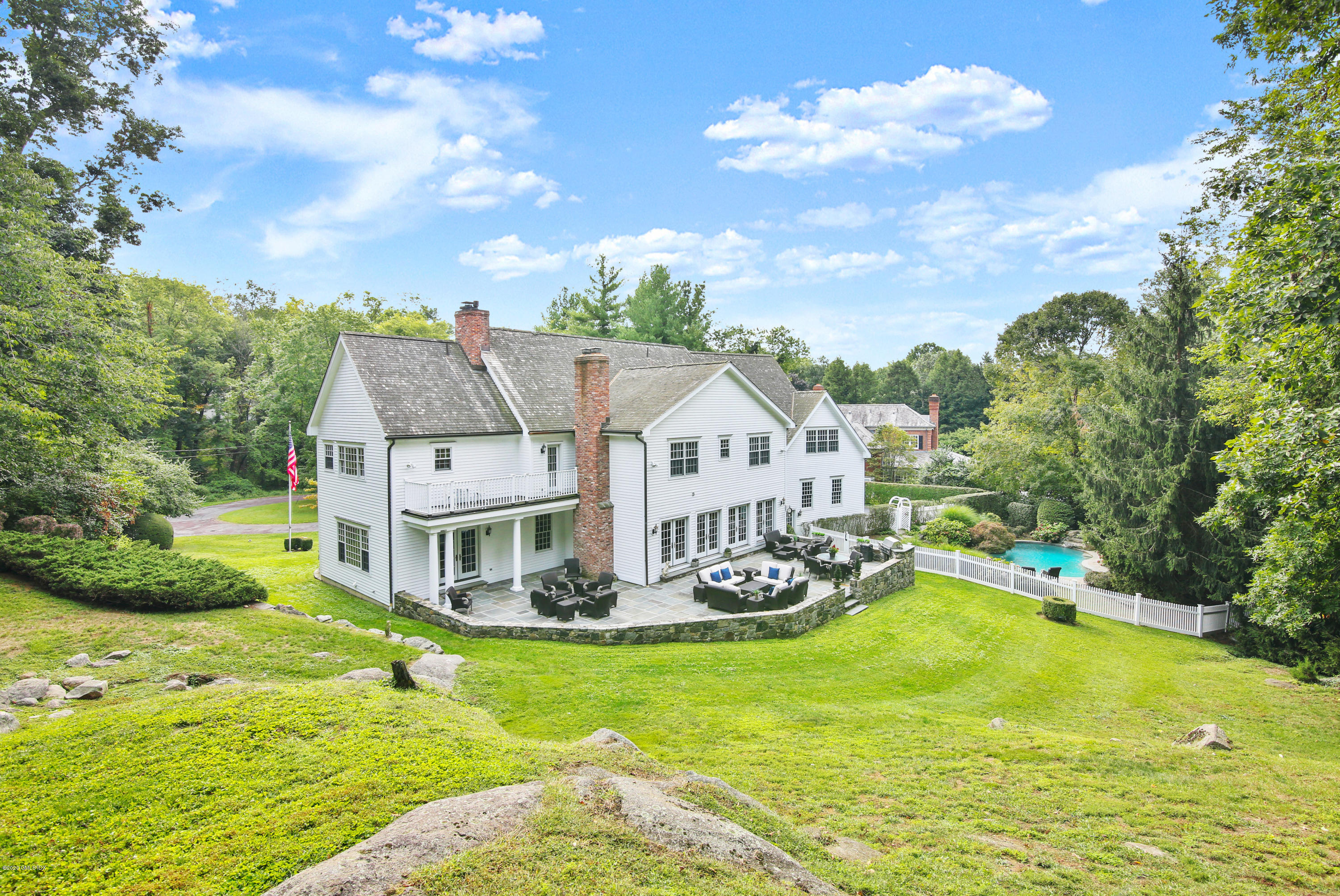 82 Round Hill Road Greenwich, CT 06831 - Photo 18 of 19 a view of a house with a big yard