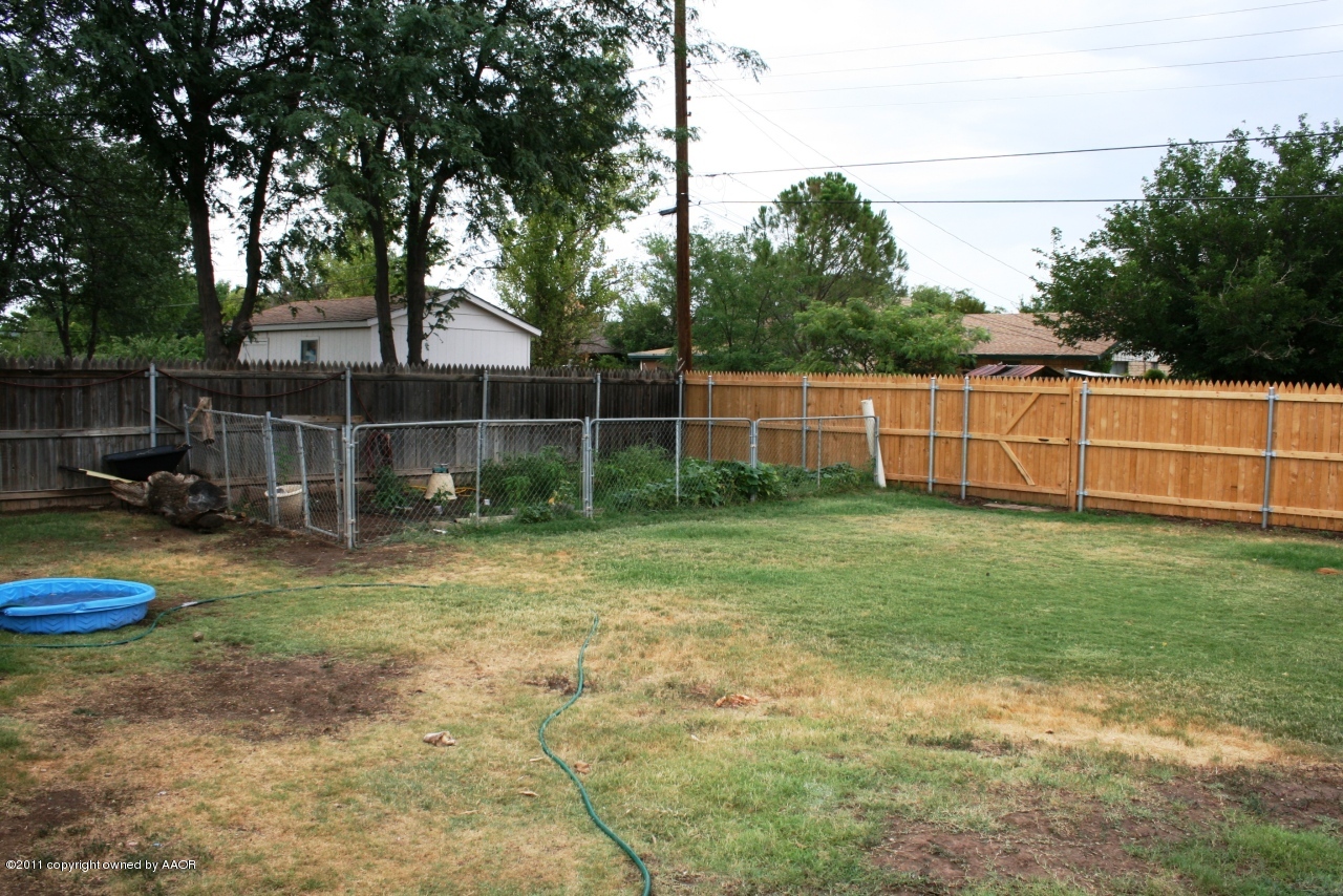 2826 Lloyd Drive Amarillo, TX 79110 - Photo 17 of 18 a view of a backyard with table and chairs and wooden fence