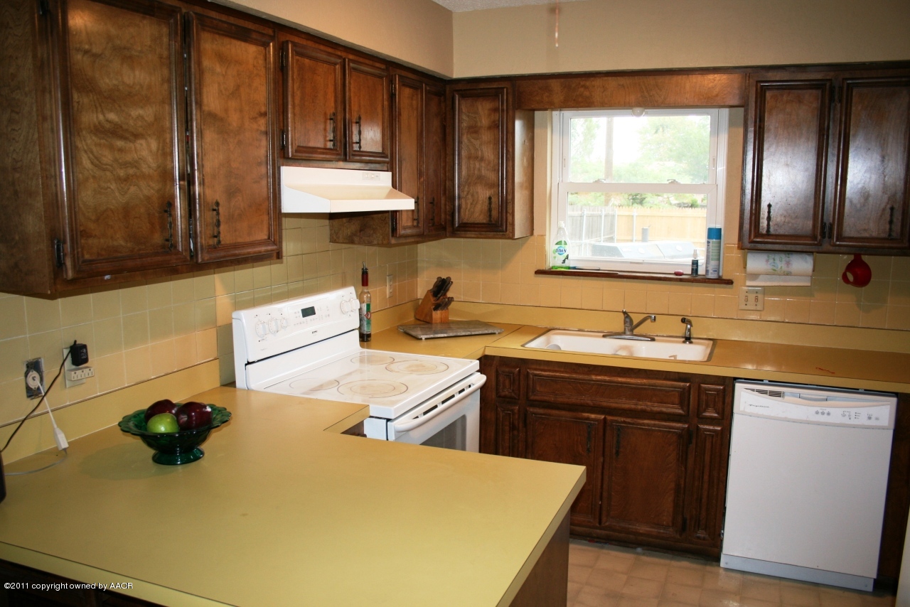 2826 Lloyd Drive Amarillo, TX 79110 - Photo 3 of 18 a kitchen with a sink a stove and cabinets