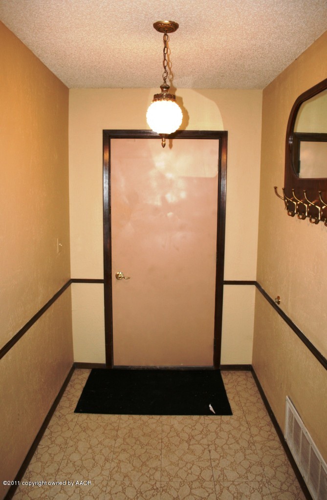 2826 Lloyd Drive Amarillo, TX 79110 - Photo 5 of 18 a view of a hallway with wooden floor and staircase
