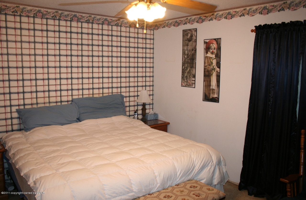 2826 Lloyd Drive Amarillo, TX 79110 - Photo 7 of 18 a large bed sitting in a bedroom next to a bathroom