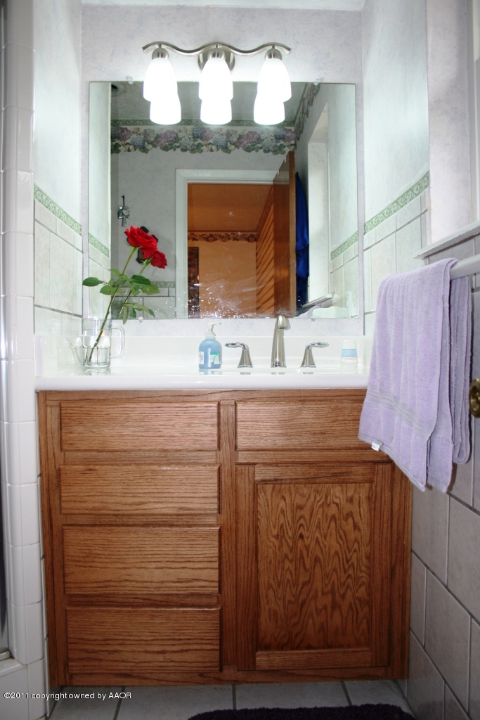 2826 Lloyd Drive Amarillo, TX 79110 - Photo 8 of 18 a bathroom with a sink vanity granite and a mirror