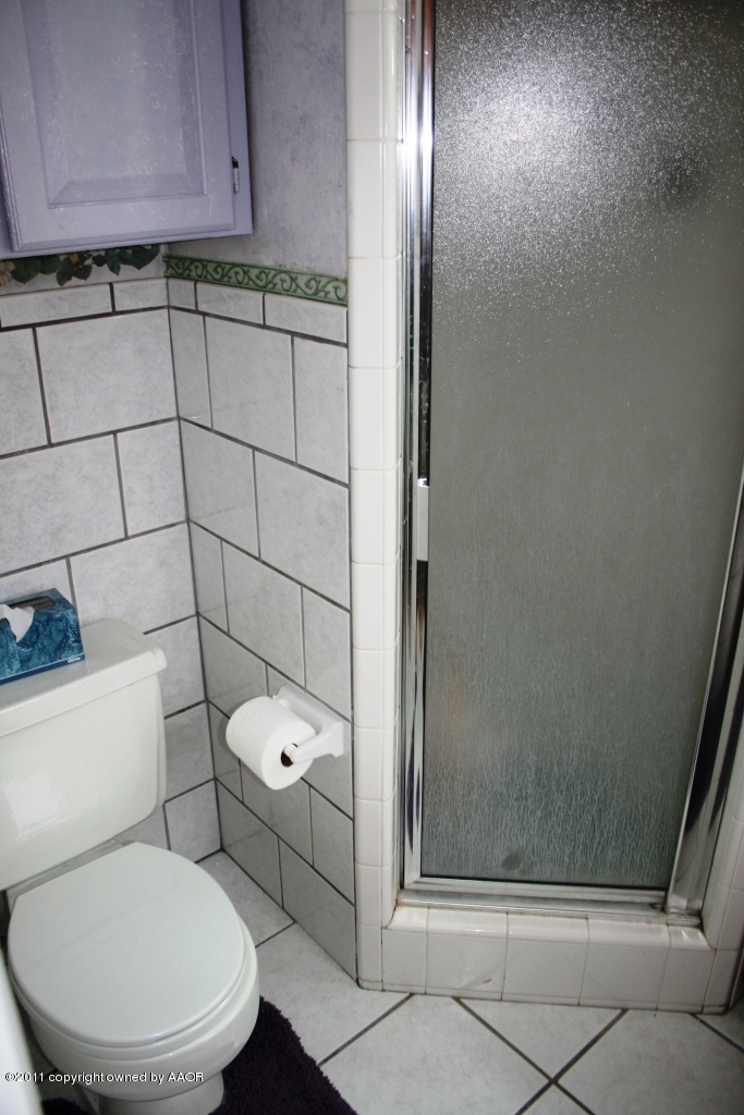 2826 Lloyd Drive Amarillo, TX 79110 - Photo 9 of 18 a bathroom with a toilet and a shower