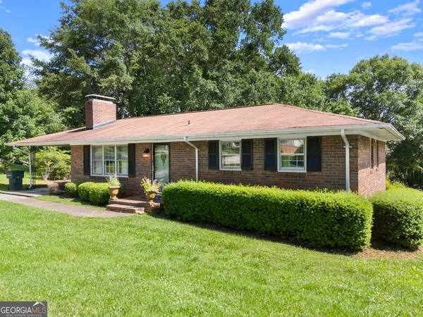a front view of a house with garden and porch