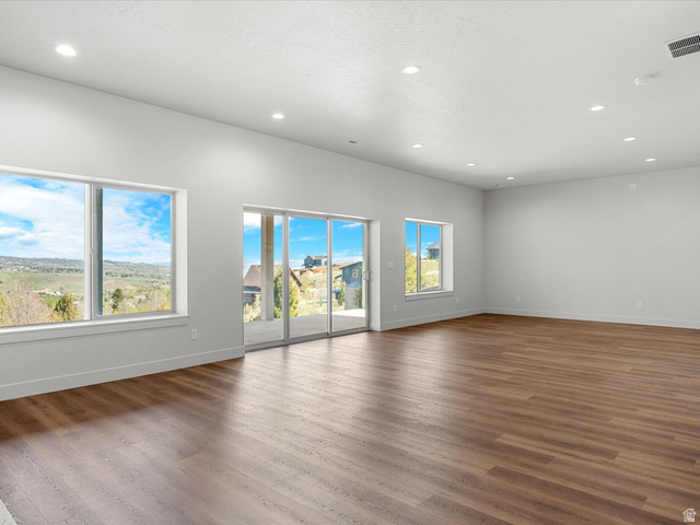 1159 North Broad Hollow Road Garden City, UT 84028 - Photo 9 of 55 Spacious interior with wood-finish flooring, recessed lighting, white walls, and broad windows